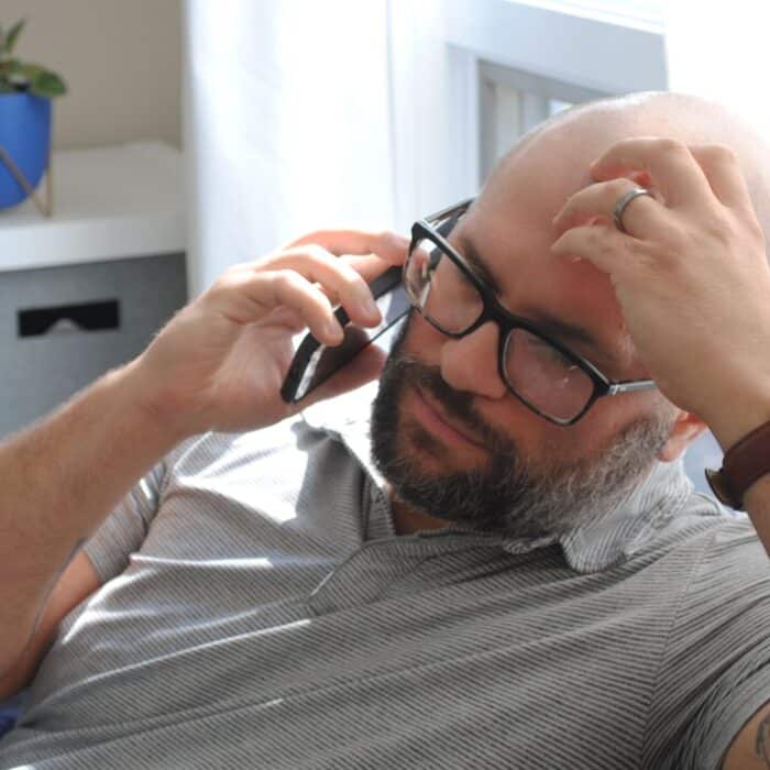 a man with glasses and a watch