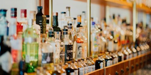 close-up photo of liquor bottles in rack