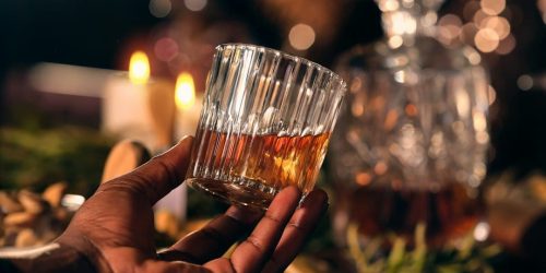 a person holding a glass of wine in their hand