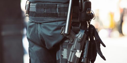 a man holding a gun and a gun holster